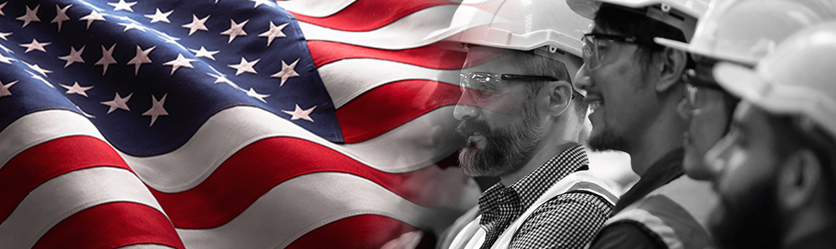 Three men with hard hats; there is a United States flag in the background.