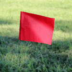 Solid Color Marking Flags In The Field Red