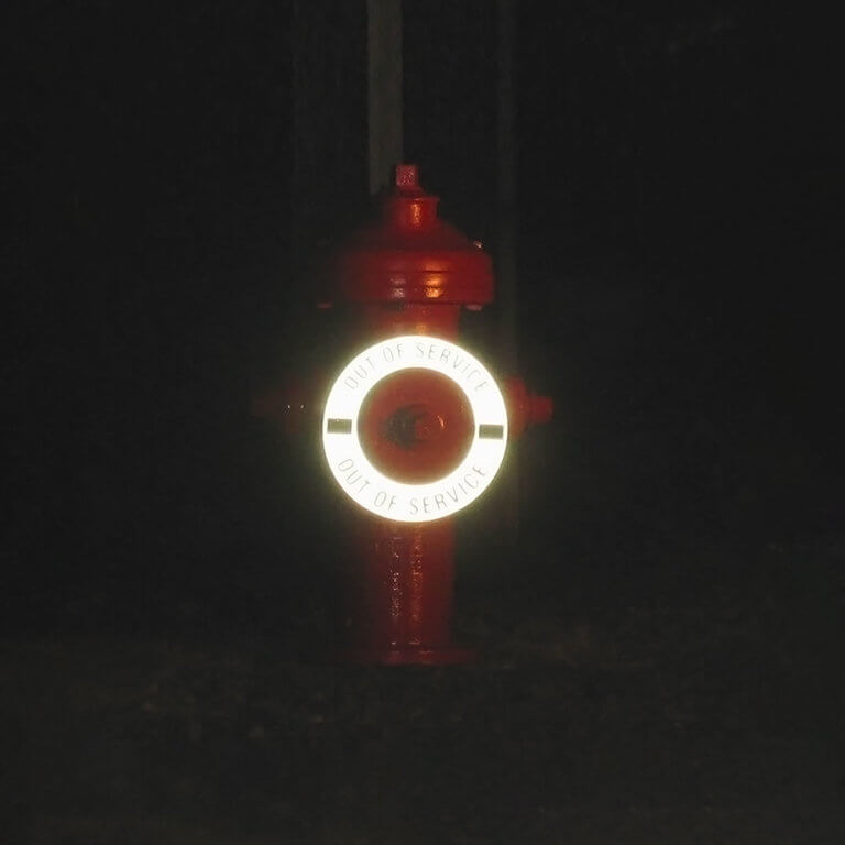 Hydrant Ring reflecting light at night