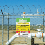 Aluminum Composite Gas Pipeline Warning Sign on a fence blocking a pipeline