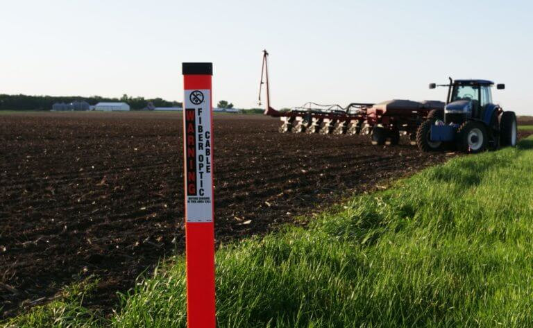 Photo of a TriView next to a farmers field indicating a Fiber Optic Line underground